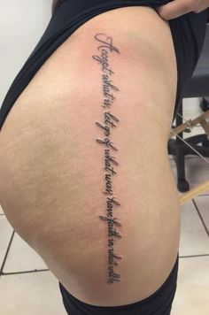 the back of a woman's thigh with writing on it