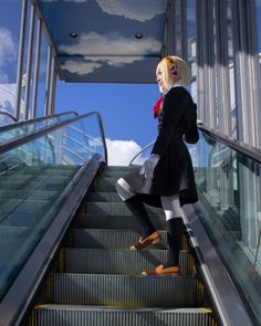 a woman with blonde hair is walking down an escalator