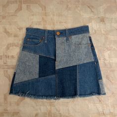 a patchwork denim skirt with buttons on the side