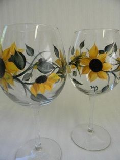 two wine glasses with sunflowers painted on them