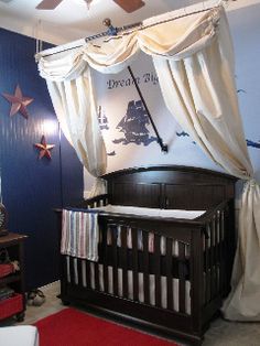 a baby's room decorated in blue, white and red with a pirate theme