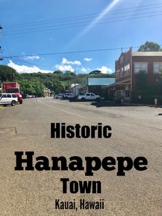 the words historic manaapee town written in black over an empty street with parked cars