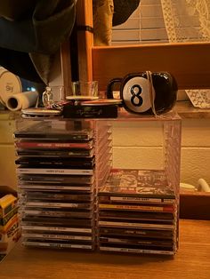 a stack of dvd's sitting on top of a wooden table