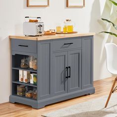 a kitchen island with two doors and shelves on the side, in front of a white wall