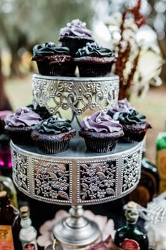 cupcakes are displayed on a tiered tray