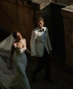 the bride and groom are walking together