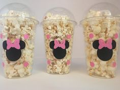 three plastic cups filled with popcorn and minnie mouse ears