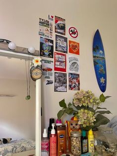 a surfboard is hanging on the wall next to various items