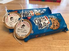 two chocolate chip cookies wrapped in cellophane and tied to twine with tags