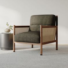 a chair sitting on top of a carpeted floor next to a potted plant