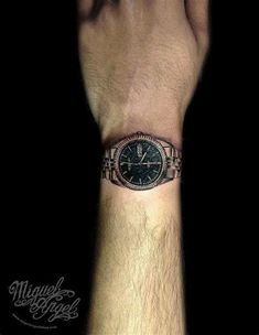 a man's wrist with a watch tattoo on it