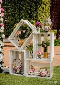 an outdoor display with flowers and plants in it