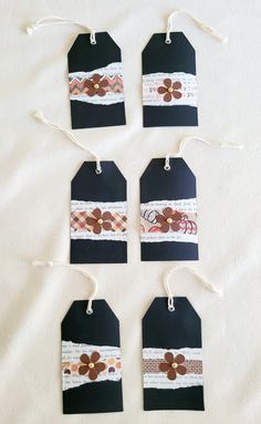 four tags with flowers and ribbons on them