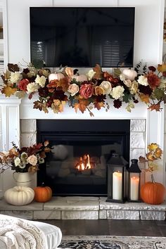 a fireplace decorated with fall flowers and candles