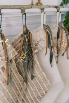 three stockings hanging from hooks on a rack