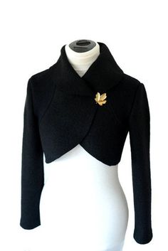 Elegant boiled wool bolero jacket. A noble icing on the cake for the everyday outfit, or as handsome companion for special occasions.  The jacket can be closed with a brooch, on request, a snap closure is attached.  Colour: Black. Back length approx: 40 cm.  Available sizes: XS, S, M, L, XL  Material: 100% wool.  Care: Dry clean only, ironing, o o Do not tumble dry.  Please specify the size you want after purchasing, the bolero jacket is then made according to your measurements specifically for Wool Capelet, Black Bolero Jacket, Classic Outfits For Women, Bolero Pattern, Elegant Jacket, Coat Women Fashion, Office Job, Womens Jackets, Bolero Jacket