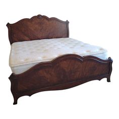 a wooden bed with a mattress on it's headboard and foot board in front of a white background