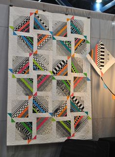 a quilt hanging on the wall next to a blow dryer