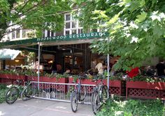 two bicycles parked in front of a restaurant