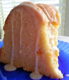 a close up of a bundt cake with icing on a blue and white plate