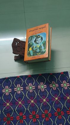 a book sitting on top of a blue rug