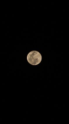 the full moon is seen in the dark sky with no clouds on it's side