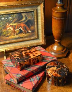 there are many different items on the table next to each other, including boxes and candles