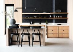 the kitchen is clean and ready to be used for dinner or breakfast time, with black chairs