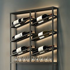 a wine rack with many bottles and glasses on it in front of a wall mounted light