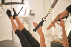 two women doing exercises on exercise equipment in a gym