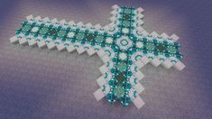 an intricately designed cross made out of white and turquoise beads on a blue background