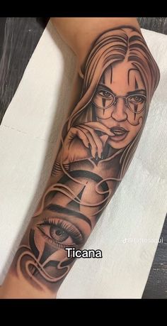 a woman's arm with an evil face and eye tattoo on the left forearm