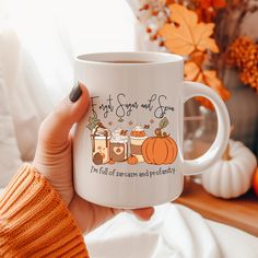 a woman holding up a coffee mug with the words first thanksgiving and honey on it