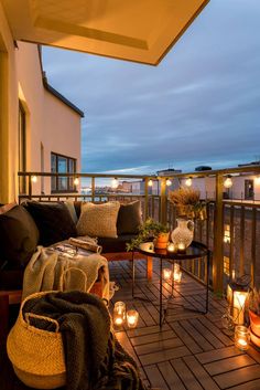 candles are lit on the deck of a house