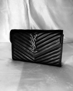 This stylish and elegant YSL black bag brings together classic and modern touches. It is completed with soft black leather texture, elegant stitching details and silver YSL logo. It is suitable for both shoulder and hand carrying thanks to its chain strap. Its small size completes your elegance in daily use. The interior is designed to fit your daily items comfortably. A perfect choice for women who want to make a difference with a vintage atmosphere. Ysl Black Bag, Black Leather Texture, Ysl Logo, Stitching Details, For Her Gifts, Black Chain, Leather Texture, Black Bag, Soft Black