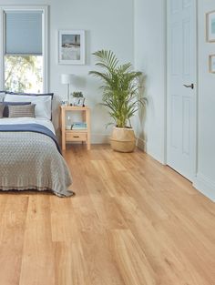 Bedroom with light blond flooring with a bed, side table and plant visible in the background. Karndean French Oak, Wooden Bedroom Flooring, Bedroom Vinyl Flooring, Wooden Bedroom Floor, Light Wood Floor Bedroom, Oak Floor Bedroom, Wood Flooring Bedroom, Wooden Floor Bedroom Ideas, Wooden Flooring Bedroom