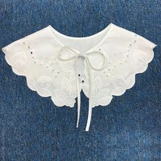 a white blouse with lace and buttons on it