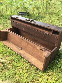 an old trunk is sitting in the grass