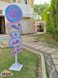 a pink and blue lollipop sign in front of a house