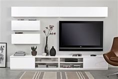 a white entertainment center with a flat screen tv mounted on it's side wall