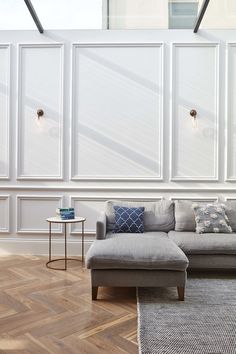 a living room with white walls and wood flooring