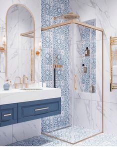 a bathroom with blue and white tiles on the walls, sink, shower stall and mirror