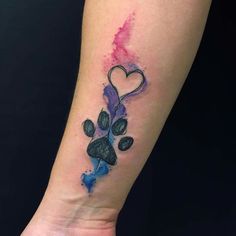 a small tattoo on the arm of a person with a heart and flowers in it