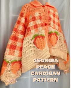 an orange and white crocheted sweater hanging on a clothes line with the words georgia peach cardigan pattern