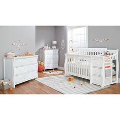 a baby's room with white furniture and gray walls