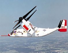 an air plane flying in the sky with two propellers on it's back end