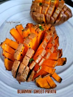 a white plate topped with sliced up sweet potatoes and slices of meat on top of it