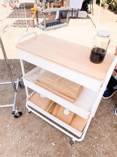 a person sitting on the ground next to a table