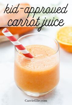 a glass filled with orange juice next to an orange slice