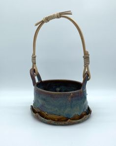 a blue and brown basket sitting on top of a white table